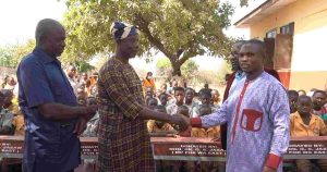 District Chief Executive (DCE), Hon. Adamu Shaibu presenting the dual desk to Mr. Yahaya Mimuni Abdul Rahaman, the district education director