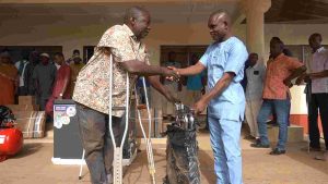 A beneficiary recieving a wheel chair