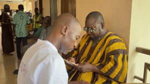 Bliss Eye Care, Dr. Zakarea Al-Hassan Balure examining coordinating director Wa east district assembly